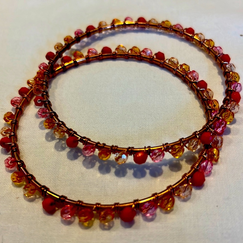 2 copper bangle bracelets wrapped with warm tone beads